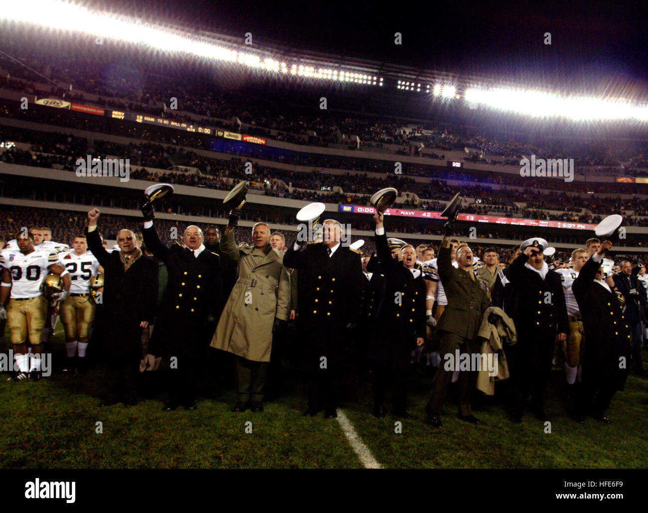 041204-N-2383B-426 Philadelphia, Pa. (Dec. 4, 2004) Ð The Navy Marine Corps leadership cheers after the traditional singing of the Alma Mater song where Navy beat Army 42 to 13 at the conclussion of their 105th meeting.  From left is Secretary of the Navy Gordon R. England, Chief of Naval Operations Adm. Vern Clark, Commandant of the Marine Corps Gen. Michael W. Hagee, Superintendent of the U.S. Naval Academy Vice Adm. Rodney P. Rempt, Commandant of Midshipmen Capt. Joe Leidig, Deputy Commandant of Midshipmen Col. David Q. Fuquea, Master Chief of the Navy Terry Scott, and Brigade Master Chief  Stock Photo