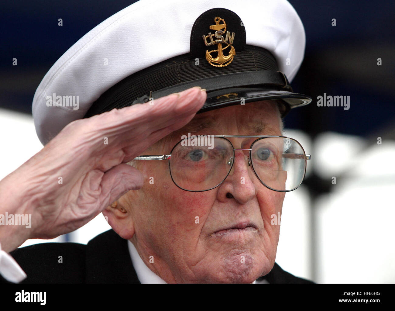 041207-N-0975R-002  Naval Station Everett, Wash. (Dec. 7, 2004) - Retired Chief Petty Officer William Brown salutes during the presentation of colors on board Naval Station Everett, Wash., during the Pearl Harbor Survivors Ceremony. Brown was at Pearl Harbor during the attack on Dec. 7, 1941. This year marked the 63rd Anniversary of the attack. U.S. Navy photo by Journalist 1st Class Ralph Radford (RELEASED) US Navy 041207-N-0975R-002 Retired Chief Petty Officer William Brown salutes during the presentation of colors on board Naval Station Everett, Wash., during the Pearl Harbor Survivors Cere Stock Photo