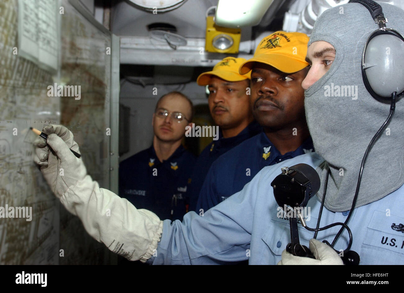 041207-N-4953E-014 Persian Gulf (Dec. 7, 2004) -  Interior Communications Electrician 2nd Class Shane Von Bergen, right, track damage control drills as Damage Control Training Team members evaluate the unit locker during a general quarters drill. Currently aircraft from Carrier Air Wing Three (CVW-3) embarked aboard Truman are providing close air support and conducting intelligence, surveillance, and reconnaissance missions in ongoing operations over Iraq. Truman's Carrier Strike Group Ten (CSG-10) and embarked CVW-3 are currently on a regularly scheduled deployment in support of the Global Wa Stock Photo