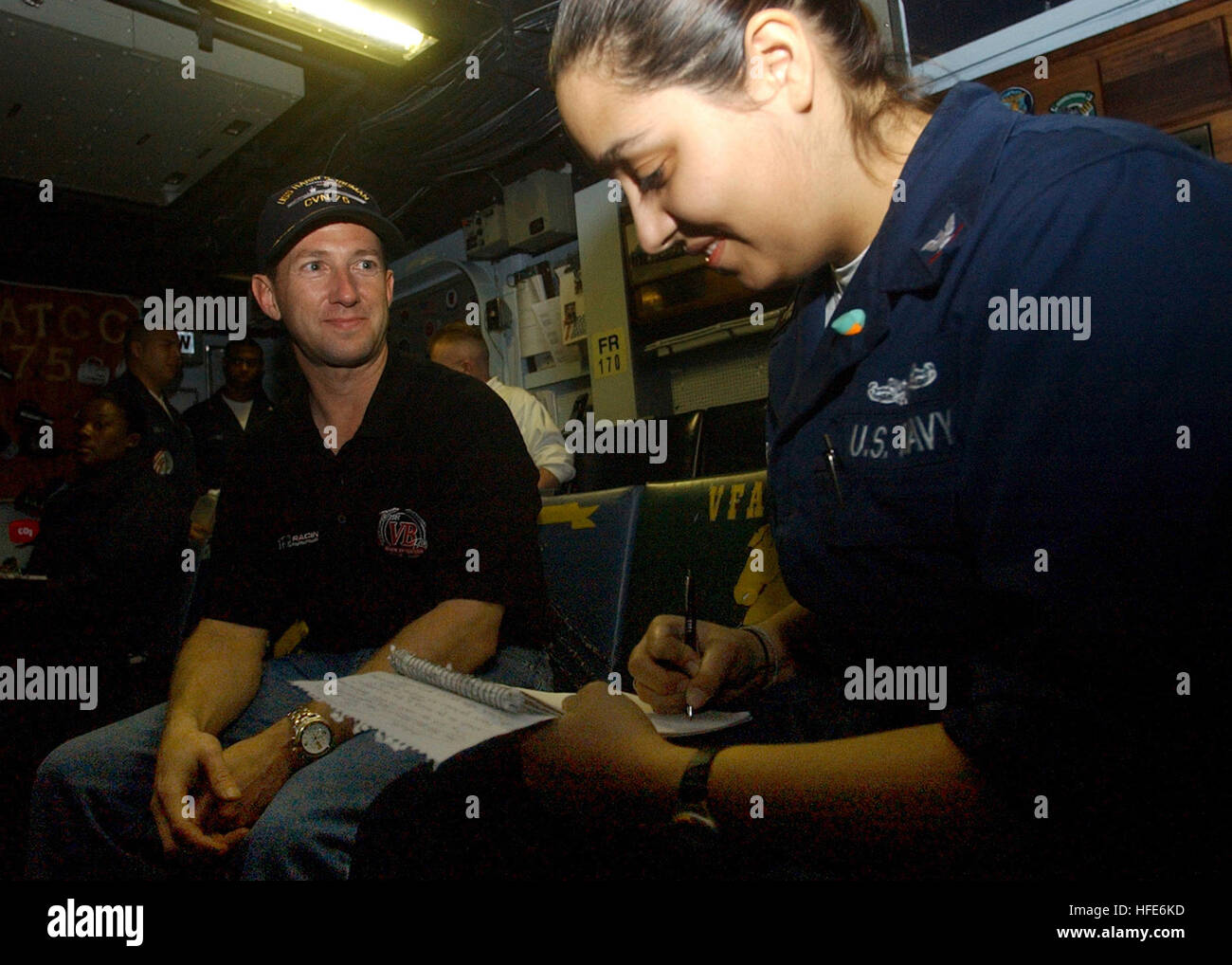041207-N-2984R-092  Persian Gulf (Dec. 7, 2004) - NASCAR Nextel Cup driver John Andretti is interviewed by Journalist 3rd Class Alma R. Larson in the Carrier Air Traffic Control Center (CATCC) aboard the Nimitz-class aircraft carrier USS Harry S. Truman (CVN 75). Carrier Air Wing Three (CVW-3) embarked aboard Truman is providing close air support and conducting intelligence, surveillance and reconnaissance missions over Iraq. TrumanÕs Carrier Strike Group Ten (CSG-10) and CVW-3 are on a regularly scheduled deployment in support of the Global War on Terrorism. U.S. Navy photo by Photographer's  Stock Photo