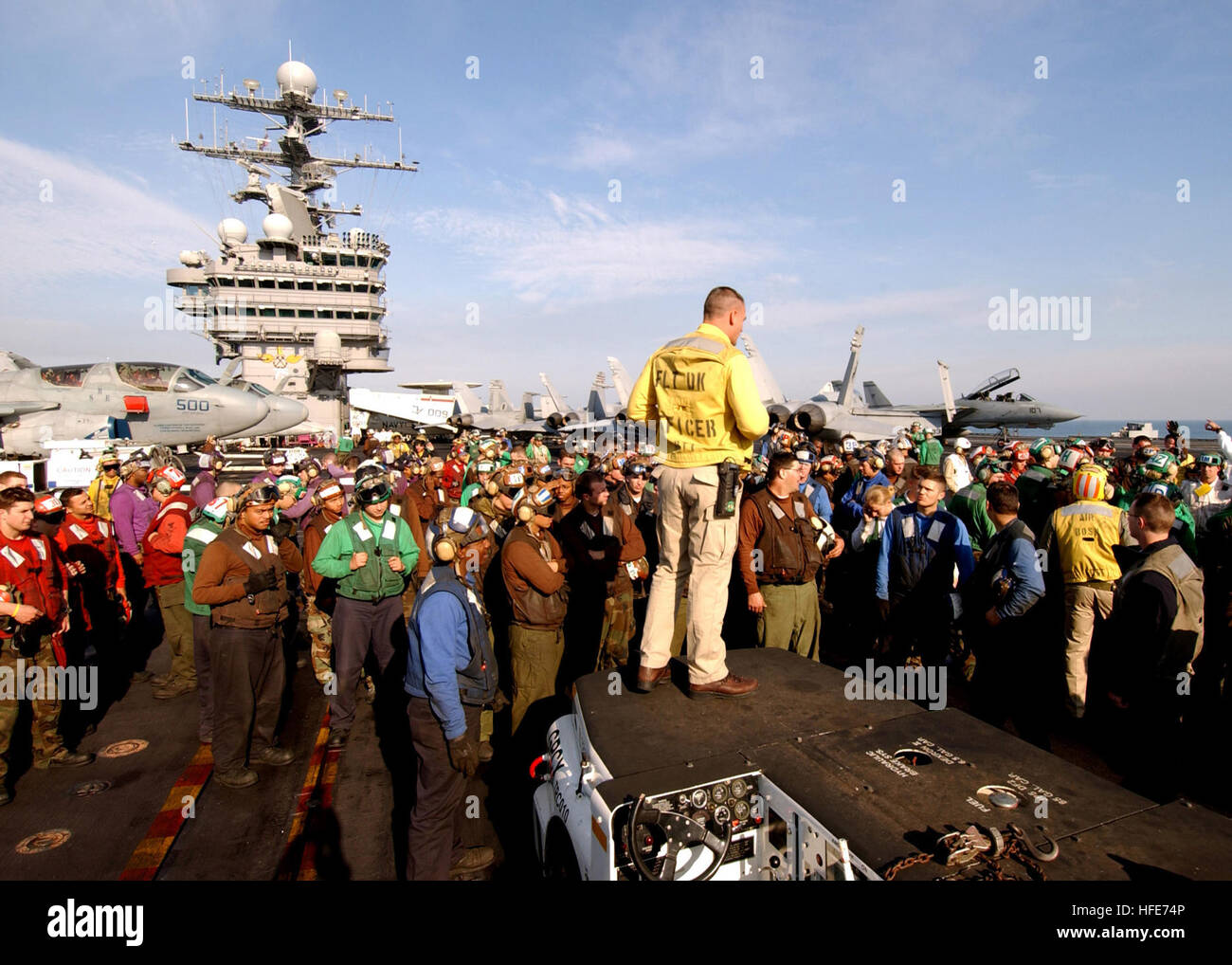 041224-N-5345W-001 (Persian Gulf)   Onboard USS Harry S. Truman (CVN-75)   Flight Deck Officer, Lieutenant Larry Spradlin stands surrounded by carrier and air wing flight deck personnel while briefing them all on the sequence of events to take place during an impending Mass Casualty drill aboard the flight deck of the Nimitz-class aircraft carrier USS Harry S. Truman.  Currently aircraft from Carrier Airwing Three (CVW-3) embarked on USS Harry S. Truman are providing close air support and conducting Intelligence, Surveillance, and Reconnaissance (ISR) missions in ongoing operations.  Truman's  Stock Photo