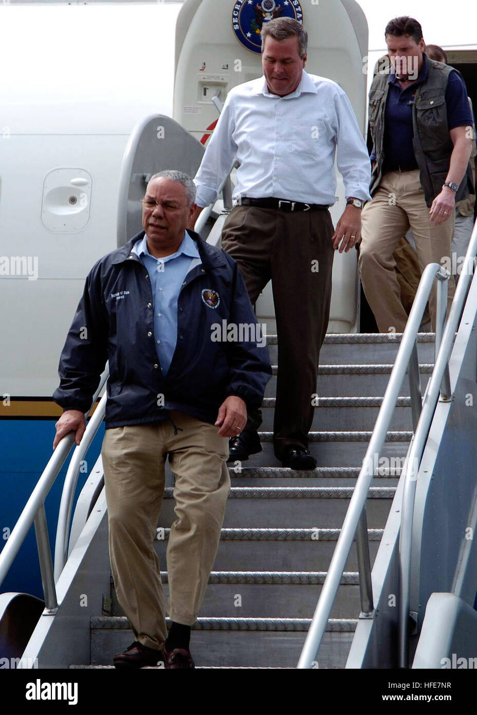 050105-N-0057P-142 Aceh, Sumatra, Indonesia (Jan. 5, 2005) - Secretary of State Colin Powell and Florida Governor Jeb Bush depart their plane after arriving in Banda Aceh, Sumatra, Indonesia, to speak with Indonesian President Susilo Yudhoyono about U.S. aide to the area. Helicopters and aircraft assigned to Carrier Air Wing Two (CVW-2) and Sailors from Abraham Lincoln are supporting Operation Unified Assistance, the humanitarian operation effort in the wake of the Tsunami that struck South East Asia. The Abraham Lincoln Carrier Strike Group is currently operating in the Indian Ocean off the w Stock Photo