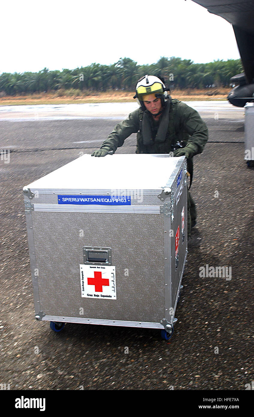 050108-N-3970R-018 Meubaloh, Sumatra, Indonesia (Jan. 8, 2005) – Cpl. Ian Ballentyne, assigned to the “White Knights” of Marine Medium Helicopter Squadron One Six Five (HMM-165), offloads medical supplies from a CH-53E Super Stallion helicopter at Muebaloh City Air Field. Helicopters from Bonhomme Richard and Sailors and Marines assigned to Expeditionary Strike Group Five (ESG-5) are supporting Operation Unified Assistance, the humanitarian operation effort in the wake of the Tsunami that struck South East Asia. The Bonhomme Richard Expeditionary Strike Group is currently operating in the Indi Stock Photo