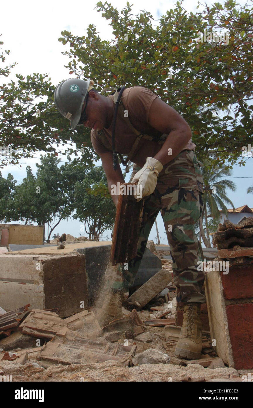 050116-N-6843I-010 Koggala, Sri Lanka (Jan.16, 2005) Ð Construction Electrician 2nd Class Jamal Redding, from Atlanta, Ga., salvages tiles from a schoolhouse destroyed by the tsunami that hit the region on Dec. 26, 2004. More than 18,000 Marines, Sailors, Airmen, Soldiers and Coast Guardsmen with Combined Support Force Five Three Six (CSF-536) are working with international militaries and non-governmental organizations to support in the relief effort as part of Operation Unified Assistance, the humanitarian relief effort to aid the victims of the tsunami that struck Southeast Asia. U.S. Navy p Stock Photo