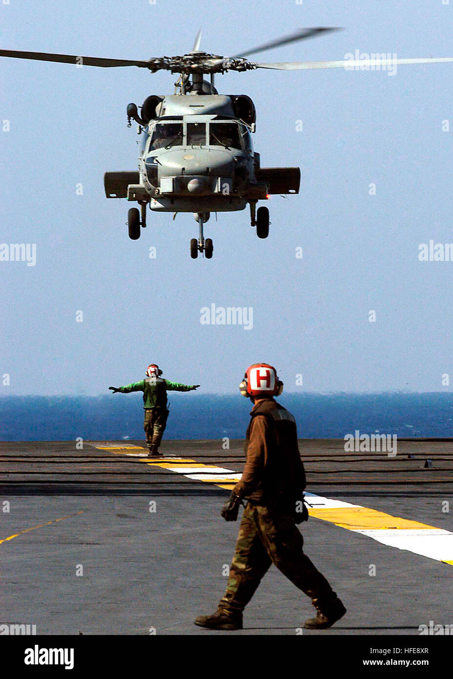 050125-N-9079D-056 Indian Ocean (Jan. 25, 2004) Ð AN SH-60B Seahawk helicopter, assigned to the ÒSaberhawksÓ of Helicopter Anti-Submarine Light Squadron Four Seven (HSL-47), prepares to land on the flight deck aboard USS Abraham Lincoln (CVN 72). The Abraham Lincoln Carrier Strike group is currently operating in the Indian Ocean off the waters of Indonesia and Thailand in support of Operation Unified Assistance, the humanitarian operation effort in the wake of the Tsunami that struck South East Asia. U.S. Navy photo by Photographer's Mate Airman Apprentice Ronald A. Dallatorre (RELEASED) US Na Stock Photo