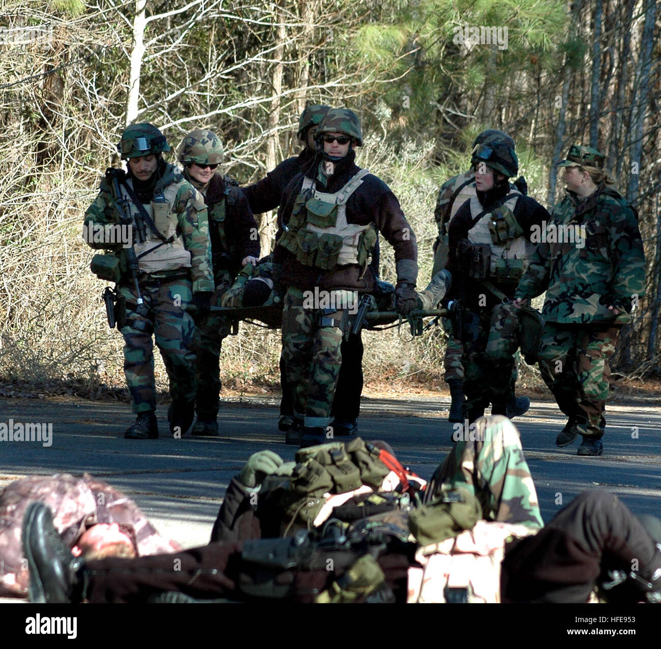 050128-N-1722M-117 Chesapeake, Va. (Jan. 28, 2005) Ð Sailors assigned to Mobile Security Squadron Six (MSS-6) carry a wounded comrade during a simulated suicide bomber exercise on board Naval Auxiliary Landing Field Fentress, Va., for the Final Evaluation Problem (FEP) prior to a deployment to the Arabian Gulf. MSS-6 is part of the new Maritime Force Protection Command created to protect U.S. assets at home and abroad. U.S. Navy photo by PhotographerÕs Mate 1st Class Michael Moriatis (RELEASED) US Navy 050128-N-1722M-117 Sailors assigned to Mobile Security Squadron Six (MSS-6) carry a wounded  Stock Photo