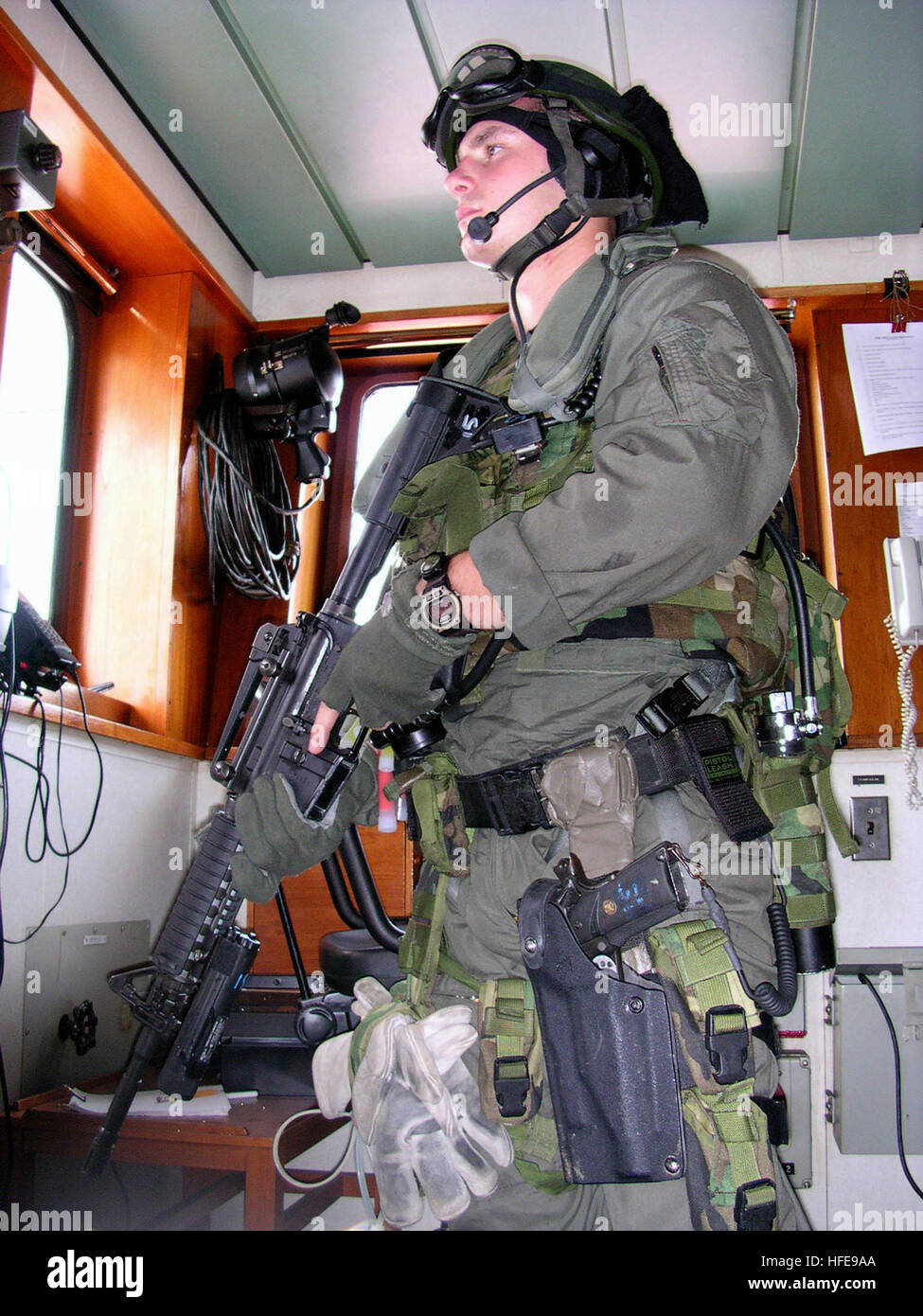 030428-N-8935H-012 At sea aboard MV PVT Franklin J. Phillips (T-AK 3004) Apr. 28, 2003 -- A U.S. Marine stands forward lookout on the bridge of the MV PVT Franklin J. Phillips after being secured during a Visit Board Search and Seizure (VBSS) drill.  The Unit Deployment Program Marines take control of a ship from a non-compliant terrorist group during the scenario.  Frank J. Phillips is an integral member of Commander, Maritime Prepositioning Ships Squadron Three (COMPSRON 3).  U.S. Navy photo by Photographer’s Mate 2nd Class Edward L Holland.  (RELEASED) US Navy 030428-N-8935H-012 A U.S. Mari Stock Photo
