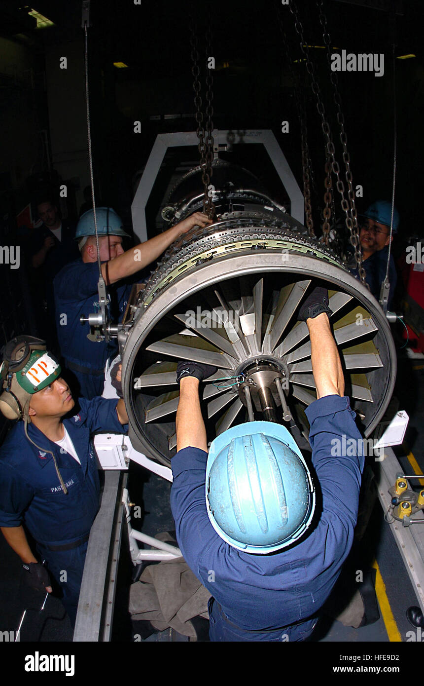 AIMD Sailors install a fan module on an F414 engine aboard USS Carl ...