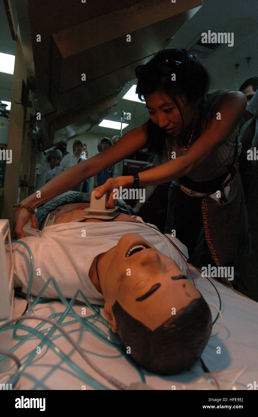 050205-N-8629M-039 Indian Ocean (Feb. 5, 2005) - Dr. Waichi Wong, of the non-governmental organization 'Project Hope', uses a defibrillator on a simulated patient during a simulated code blue drill aboard the Military Sealift Command (MSC) hospital ship USNS Mercy (T-AH 19). The drill allowed military members and 'Project Hope' medical personnel an opportunity to work with and learn from one another. Mercy has been forward deployed to assist in humanitarian aid efforts currently in progress. Mercy will serve as an enabling platform to assist humanitarian operations ashore in ways that host nat Stock Photo