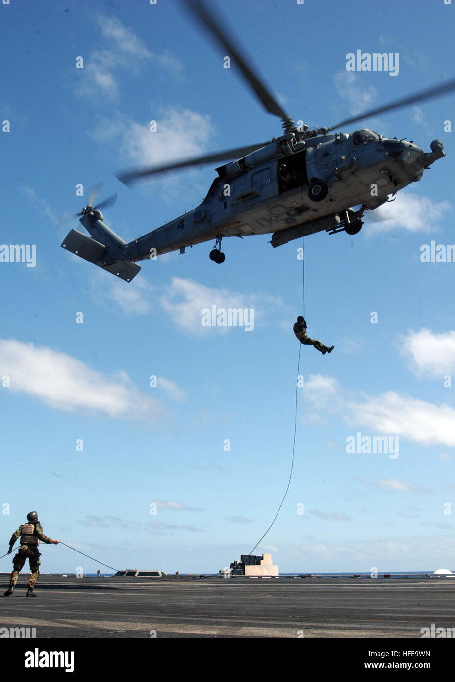 050214-N-7265L-015 Pacific Ocean (Feb. 14, 2005) Ð Sailors assigned to Explosive Ordnance Disposal Mobile Unit Eleven (EODMU-11), Detachment Nine, fast rope from an HH-60H Seahawk helicopter to the flight deck aboard the Nimitz-class aircraft carrier USS Carl Vinson (CVN 70) during an exercise. Carl Vinson is on a scheduled deployment and will arrive in Norfolk, Va., upon completion of her deployment to prepare her for refueling and a complex overhaul. U.S. Navy photo by Photographer's Mate 2nd Class Inez Lawson (RELEASED) US Navy 050214-N-7265L-015 Sailors assigned to Explosive Ordnance Dispo Stock Photo