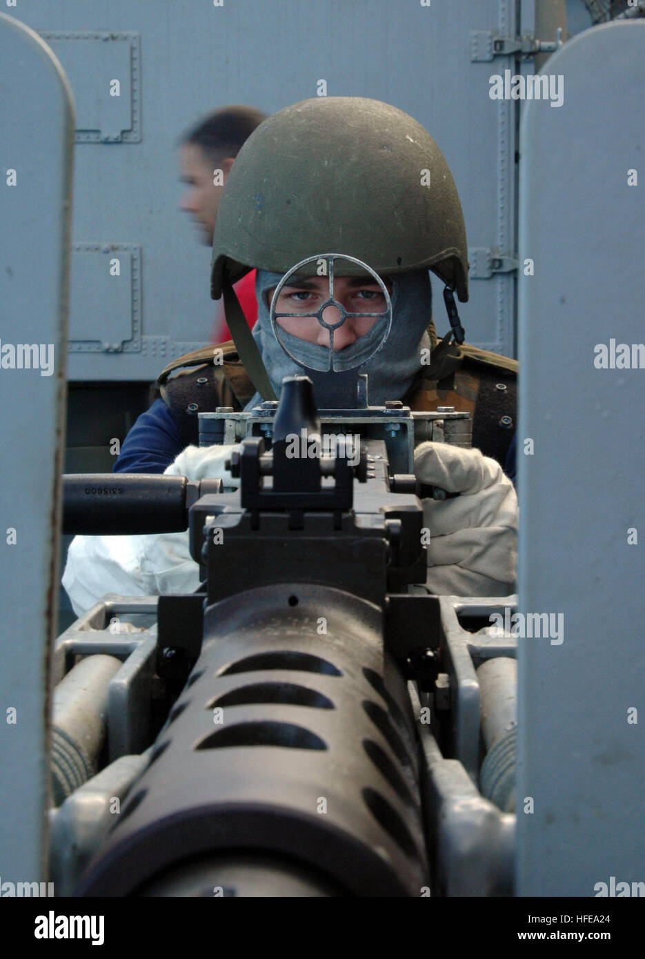 A Disbursing Clerk 3rd Class mans a .50 caliber machine gun during a ...