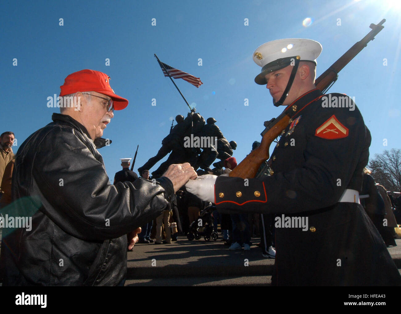 050219-N-8502J-009 Arlington, Va. (Feb. 19, 2005) - Lance Cpl. Nathan Hockenberry, right, presents Battle of Iwo Jima survivor George Cattelona, a shell casing following a remembrance ceremony held at the U.S. Marine Corps Memorial in Arlington, Va. Cattelona was among many Iwo Jima survivors to attend the wreath-laying ceremony, marking 60 years since the start of the Battle of Iwo Jima. U.S. Navy photo by Journalist 1st Class Mike Jones (RELEASED) US Navy 050219-N-8502J-009 Lance Cpl. Nathan Hockenberry, right, presents Battle of Iwo Jima survivor George Cattelona, a shell casing following a Stock Photo