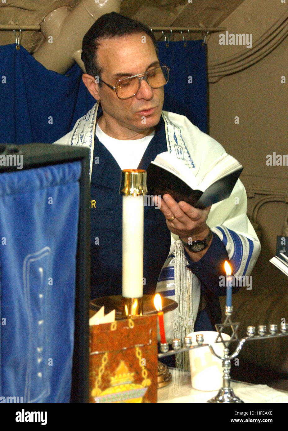 021130-N-1159M-002 At sea aboard USS Abraham Lincoln (CVN 72) Nov. 30, 2002 -- A Jewish chaplain conducts services aboard the aircraft carrier.  Chaplains of all faiths serve aboard ships around the world, bringing counseling and spiritual sustenance to Sailors at sea.   In 1941, during the attack on Pearl Harbor, Hawaii, it was a Navy Chaplain who is said to have uttered the legendary battle cry 'Praise the Lord and pass the ammunition!'  Over the last few years, the Muslim and Buddhist faiths have been added to the Chaplain Corps.  U.S. Navy Photo.  (RELEASED) US Navy 021130-N-1159M-002 Jewi Stock Photo
