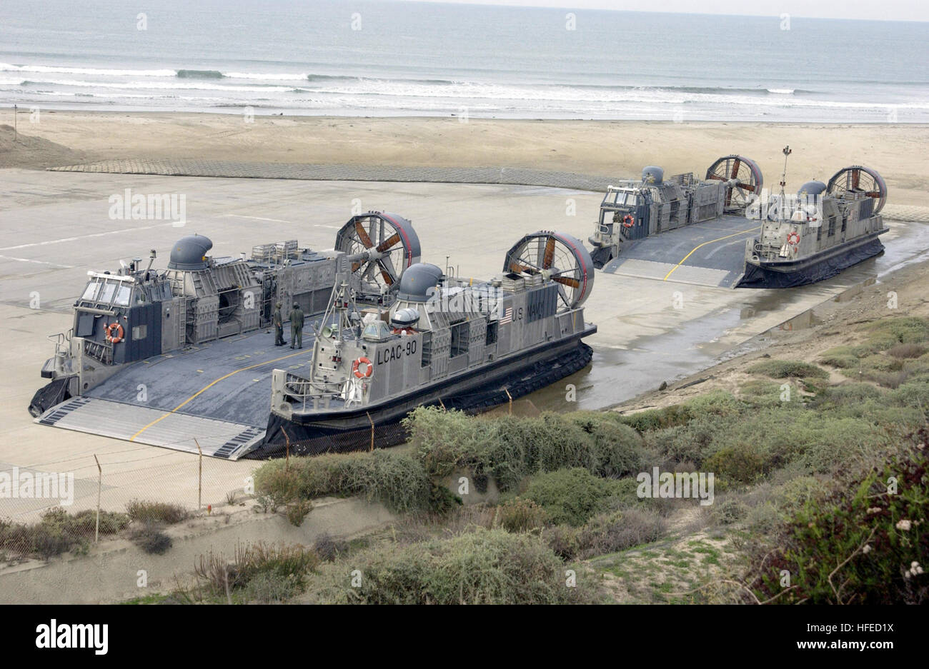 021211-N-5232L-002 Camp Pendleton, Calif. (Dec. 11, 2002) -- Two Landing Craft Air Cushions (LCAC) assigned to the 'Swift Intruders' of Assault Craft Unit Five (ACU-5) prepare for early morning exercises near Camp Pendleton Marine Corps Station.  LCAC's provide amphibious forces the speed and flexibility to land Marine units and heavy equipment on hostile shores.  U.S. Navy photo by PhotographerÕs Mate Airman Jason D. Landon.  (RELEASED) US Navy 021211-N-5232L-002 LCAC's prepare for early morning exercises Stock Photo