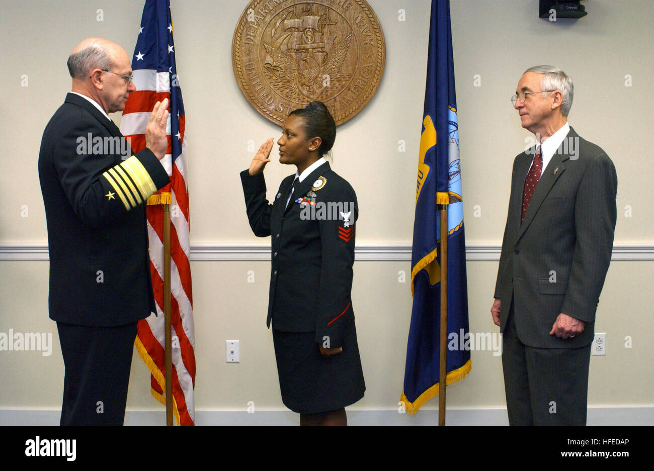 021212-N-2383B-515 Pentagon, Arlington, Va. (Dec. 12, 2002) -- Secretary of the Navy, Gordon R. England (right) watches Storekeeper 2nd Class Samantha Romero-Green, the Enlisted Recruiter of the Year get promoted to the rank of First Class Petty Officer by Admiral Vern Clark, Chief of Naval Operations (CNO), at a special ceremony held at the Pentagon.  U.S. Navy photo by Chief Photographer's Mate Johnny Bivera.  (RELEASED) US Navy 021212-N-2383B-515 Secretary of the Navy, Gordon R. England (right) watches Storekeeper 2nd Class Samantha Romero-Green, the Enlisted Recruiter of the Year get promo Stock Photo