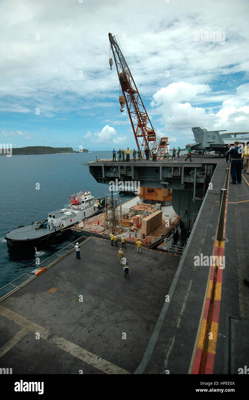 050606-N-5781F-004 Pacific Ocean (June 6, 2005) - USS Kitty Hawk (CV 63) receives aircraft parts for the E-2C Hawkeye of Carrier Airborne Early Warning Squadron One One Five (VAW-115) while anchored in Apra Harbor, Guam. The Hawkeye is a carrier-based, propeller-driven aircraft that provides airborne early warning, threat analysis, and air-control functions to the carrier strike group. Currently underway in the 7th Fleet area of responsibility (AOR), Kitty Hawk demonstrates power projection and sea control as the U.S. Navy's only permanently forward-deployed aircraft carrier, operating from Yo Stock Photo