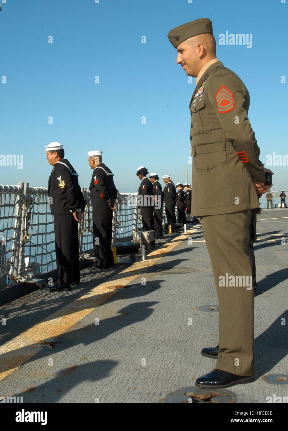 032807-N-7029R-024 SAN DIEGO (March 28, 2007) – Gunnery Sgt. Octavio Gonzalez looks on as Sailors man the rails on board USS Pearl Harbor (LSD 52) during the departure ceremony. The dock landing ship is scheduled to participate in Partnership of the Americas (POA) 2007. POA 2007 will focus on enhancing relationships with regional partner nations during a variety of exercises and events at sea and on shore through out Latin America and the Caribbean. U.S. Navy photo by Mass Communication Specialist 2nd Class Alexia M. Riveracorrea (RELEASED) US Navy 032807-N-7029R-024 Gunnery Sgt. Octavio Gonza Stock Photo