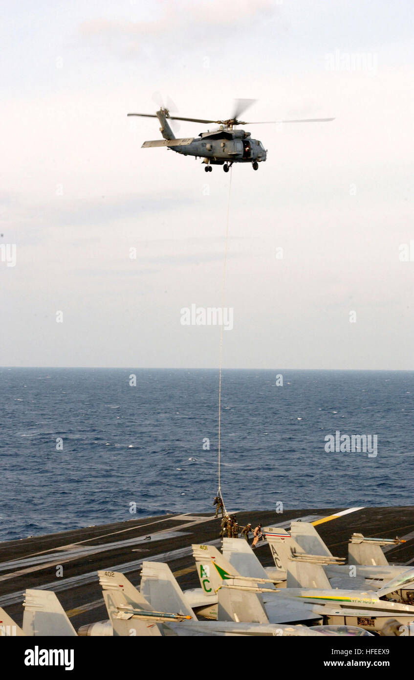 030114-N-3665W-025 At sea aboard USS Harry S. Truman (CVN 75) Jan. 14, 2003 -- Explosive Ordnance Disposal (EOD) personnel are lifted off the ship’s flight deck by a HH-60H “Sea Hawk” assigned to the “Dusty Dogs” of Helicopter Antisubmarine Squadron Seven (HS-7), while practicing Special Purpose Insertion Extraction (SPIE) rigging maneuvers. USS Harry S. Truman and Carrier Air Wing Three (CVW-3) are currently on a regularly scheduled deployment, conducting missions in support of Operation Enduring Freedom.  U.S. Navy Photo by Photographer's Mate Airman Nichole E. Wozny. (RELEASED) US Navy 0301 Stock Photo