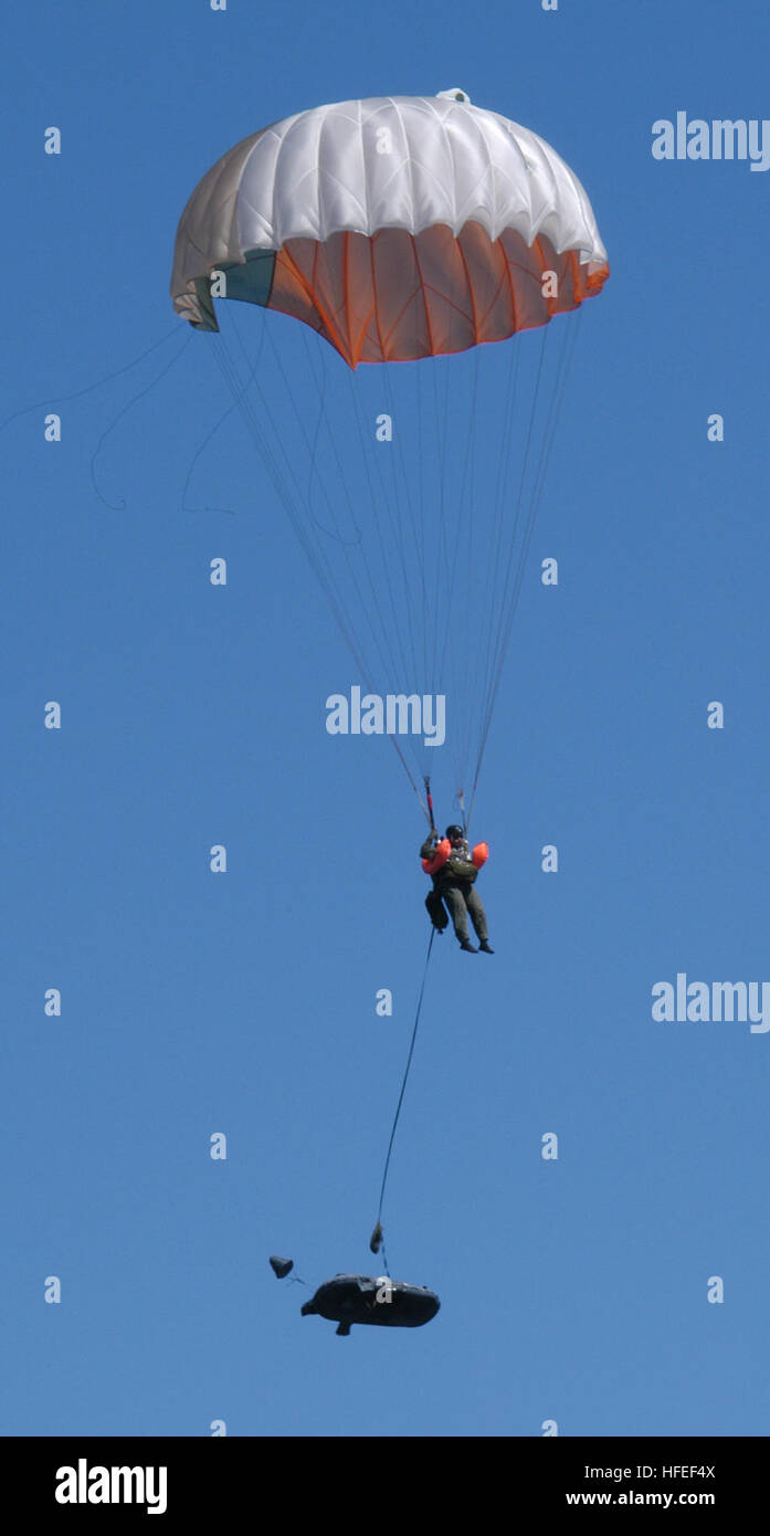 031216-N-5328N-013 Pensacola, Fla. (Dec. 16, 2003) -- An Air Force Staff Sgt. assigned to Air Force Water Survival School at Naval Air Station Pensacola, prepares for his landing by utilizing an emergency parachute, inflatable life preserver and single-person life raft.  The schoolÕs mission is to ensure each student is prepared to survive an ejection or bailout at sea. Subjects taught at the survival school include: parachuting into water, survival equipment, search and rescue techniques, medical and psychological aspects of sea survival, and hazardous marine life.  Hands-on training is empha Stock Photo