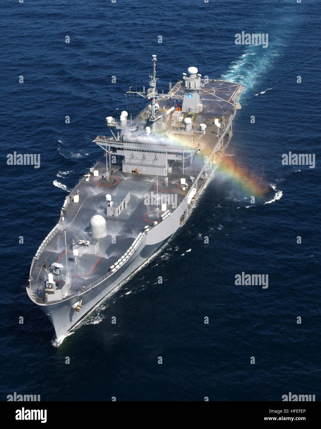030205-N-4294K-002 Horn of Africa (Feb. 5, 2003) - A small rainbow cascades across the 2nd Fleet command and control ship USS Mount Whitney (LCC 20) as she tests her Counter Measure Wash Down System (CMWDS). The wash-down system is used to help the ship combat a Chemical, Biological or Radiological attack. Mount Whitney and embarked Marines are deployed to the Horn of Africa region to participate in Operation Enduring Freedom (OEF) and the continuing Global War on Terrorism. U.S. Navy photo by Photographer's Mate 2nd Class George Kusner. (RELEASED) US Navy 030205-N-4294K-002 A small rainbow ca Stock Photo