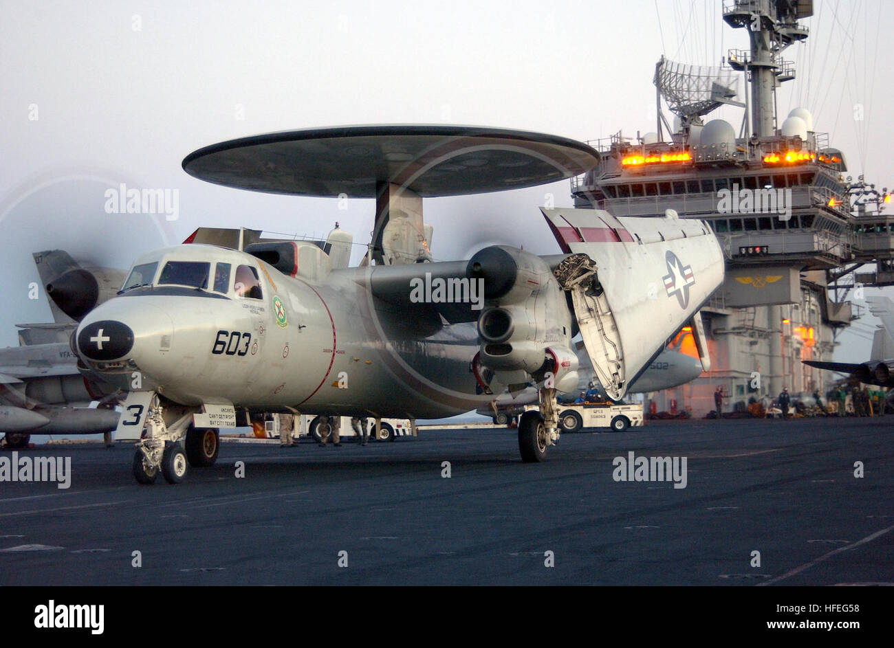 030228-N-1810F-010 Arabian Gulf (Feb. 28, 2003) -- An E-2C ÒHawkeyeÓ assigned to the ÒLiberty BellsÓ of Carrier Airborne Early Warning Squadron One One Five (VAW 115), maneuvers the flight deck aboard USS Kitty Hawk (CV 63) during preparations for launch.  Kitty Hawk and Carrier Air Wing Five (CVW-5) are operating with coalition forces in support of Operation Southern Watch and Enduring Freedom, and is the worldÕs only permanently forward-deployed aircraft carrier operating out of Yokosuka, Japan.  U.S. Navy photo by PhotographerÕs Mate 3rd Class Todd Frantom.  (RELEASED) US Navy 030228-N-1810 Stock Photo