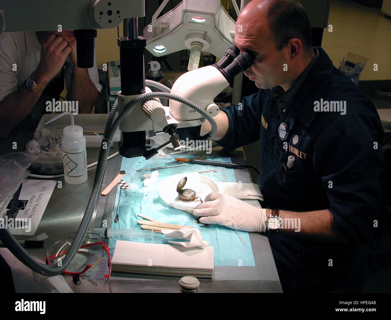Senior conservator examines a pocket watch retrieved from the Civil War ...