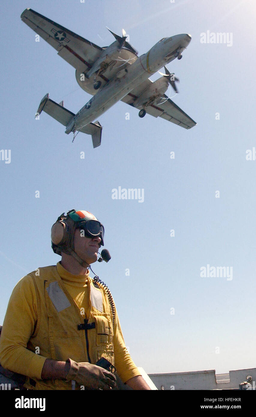 030328-N-1810F-003 The Arabian Gulf (Mar. 28, 2003) -- U.S. Navy Lt. Mark Kekeisen from Lakehurst, N.J., acts as the safety observer along the flight deck foul-line as an E-2C Hawkeye assigned to the ÒLiberty BellsÓ of Carrier Airborne Early Warning Squadron One Fifteen (VAW-115) lands aboard the aircraft carrier USS Kitty Hawk (CV 63). Kitty Hawk and her embarked Carrier Air Wing Five (CVW-5) are currently operating with coalition forces in support of Operation Iraqi Freedom, the multi-national coalition effort to liberate the Iraqi people, eliminate IraqÕs weapons of mass destruction and end Stock Photo
