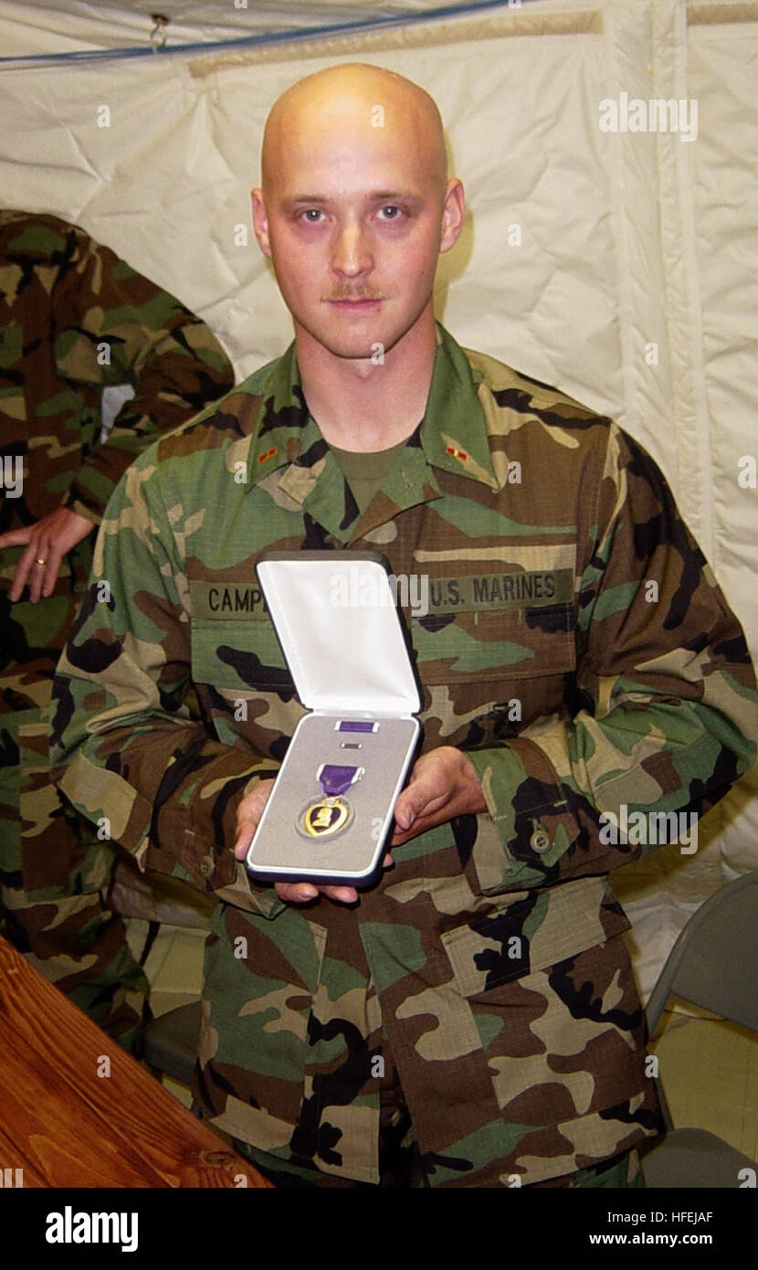 030407-N-7438S-001 Naval Station Rota, Spain (Apr. 7, 2003) -- Marine Chief Warrant Officer Chris Campbell assigned to the 2nd Battalion, 8th Marines displays his Purple Heart Medal to reporters during a press conference held at  Fleet Hospital Eight. Campbell was wounded in the arm by shrapnel during a battle at Nasiriyah, Iraq on March 26.  U.S. Navy photo by Chief Journalist Dan Smithyman.  (RELEASED) US Navy 030407-N-7438S-001 Marine Chief Warrant Officer Chris Campbell assigned to the 2nd Battalion, 8th Marines displays his Purple Heart Medal to reporters during a press conference held at Stock Photo