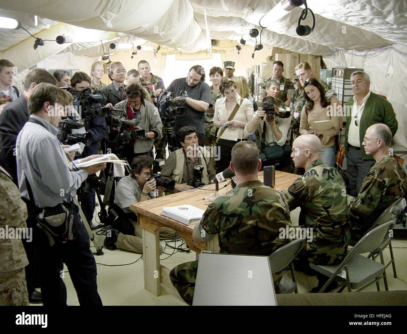 030407-N-7438S-002 Naval Station Rota, Spain (Apr. 7, 2003) -- Marine Chief Warrant Officer Chris Campbell assigned to the 2nd Battalion, 8th Marines (middle seated) addresses a pool of international media at Fleet Hospital Eight. Campbell was wounded in the arm by shrapnel during a battle at Nasiriyah, Iraq on March 26, and was sent to Rota, Spain for follow-up treatment. Campbell was award the Purple Heart for his injury in battle.  U.S. Navy photo by Chief Journalist Dan Smithyman.  (RELEASED) US Navy 030407-N-7438S-002 Marine Chief Warrant Officer Chris Campbell assigned to the 2nd Battali Stock Photo