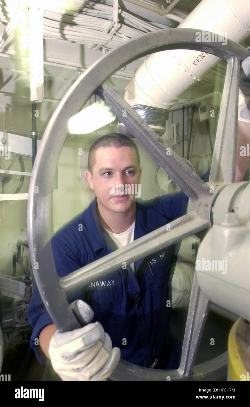 030506-N-0413R-001 The Arabian Gulf (May 6, 2003) -- Fireman Kevin Conaway turns the catapult steam cross connecting valve in the catapult steam room aboard USS Nimitz (CVN 68).  Nimitz Carrier Strike Force and Carrier Air Wing Eleven (CVW-11) are deployed conducting missions in support of Operation Iraqi Freedom.  Operation Iraqi Freedom is the multi-national coalition effort to liberate the Iraqi people, eliminate IraqÕs weapons of mass destruction, and end the regime of Saddam Hussein.  U.S. Navy photo by PhotographerÕs Mate Airman Shannon E. Renfroe.  (RELEASED) US Navy 030506-N-0413R-001  Stock Photo