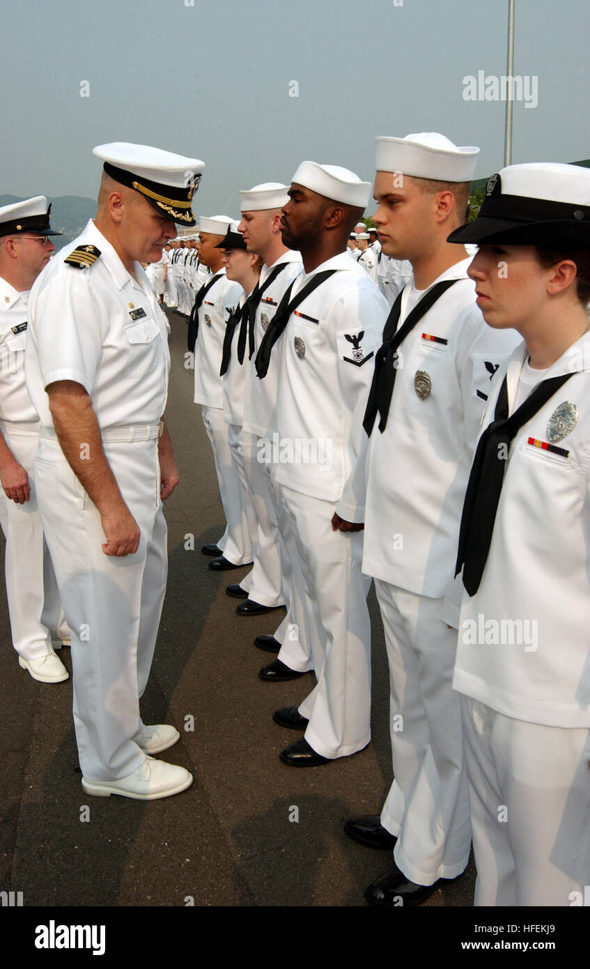 030523-N-2420K-003 Sasebo, Japan (May 23, 2003) -- Sailors assigned to Fleet Activities Sasebo, Japan stand at attention while Capt. Michael James, Commander Fleet Activities Sasebo performs a service dress white uniform inspection.  U.S. Navy photo by PhotographerÕs Mate 2nd Class Jonathan R. Kulp.  (RELEASED) US Navy 030523-N-2420K-003 Sailors assigned to Fleet Activities Sasebo, Japan stand at attention Stock Photo