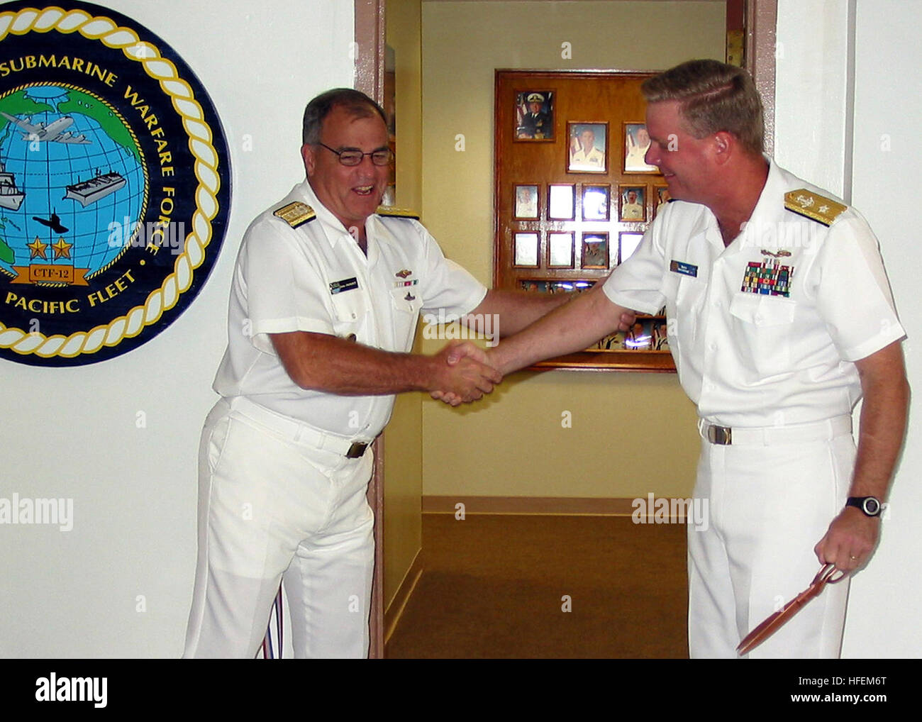 030604-N-0879R-001 Naval Station Pearl Harbor, Hawaii (Jun. 4, 2003) -- Rear Adm. John Padgett, Commander Submarine Force, U.S. Pacific Fleet (left) and Rear Adm. Barry McCullough, Commander, Navy Region Hawaii, officially open new office spaces for Commander Antisubmarine Warfare Force U.S. Pacific Fleet (CTF-12). CTF-12 exercises overall responsibility for the conduct of Theater USW and surveillance including tasking of assigned forces for the conduct of USW and Ocean surveillance and reconnaissance operations within assigned area of operations, normally under 3rd Fleet control, and operate  Stock Photo