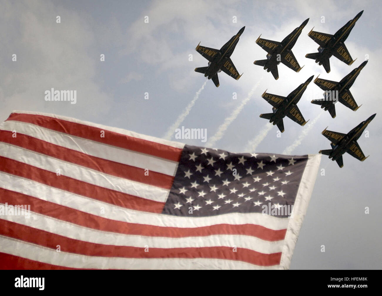 030626-N-1539M-002 North Kingstown, R.I.  (June 26, 2003) - The U.S. Navy's Flight Demonstration Team, 'Blue Angels', soars over Old Glory as they perform the 'Delta Formation' during an air show in North Kingstown, R.I., celebrating the centennial of powered flight. U.S. Navy photo by Photographer's Mate 2nd Class Saul McSween.  (RELEASED) US Navy 030626-N-1539M-002 The U.S. Navy's Flight Demonstration Team, Blue Angels soars over Old Glory as they perform the Delta Formation during an air show in North Kingstown, R.I Stock Photo