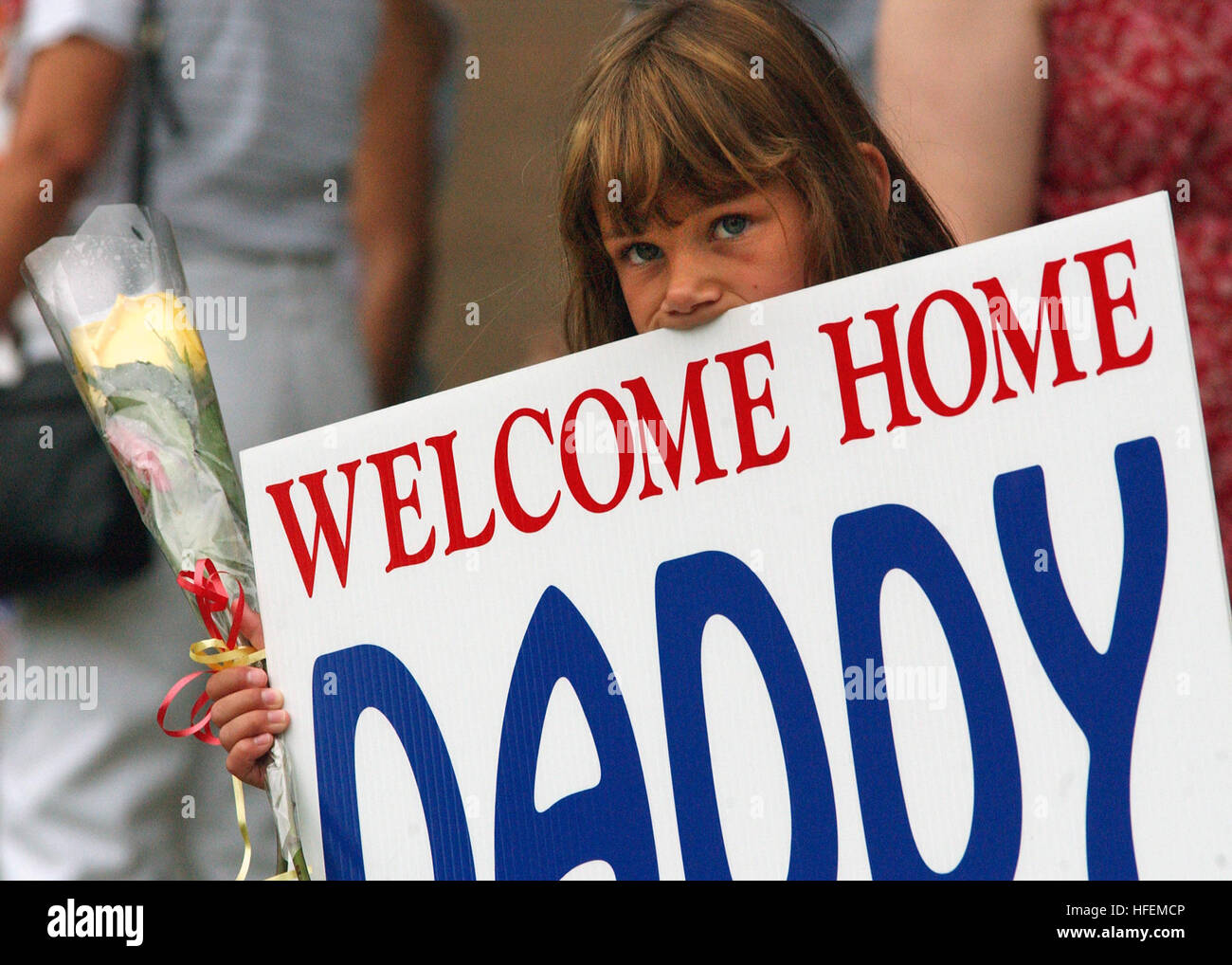 030708-N-5576W-001 Naval Station Great Lakes, Ill. (Jul. 8, 2003) – The daughter of Gunnery Sgt. Gary Jacobs assigned to the Marine Wing Communications Squadron (MWCS-48), a Marine Reserve Unit stationed at Great Lakes Ill., awaits for her Dad's return from Operation Iraqi Freedom. About 100 Marines, consisting of both active and reserve Marines from the unit, returned to Naval Station Great Lakes. The group deployed to the Middle East in February and provided command and control functions, and were involved in operations from Kuwait to Baghdad. U.S. Navy photo by Photographer's Mate Stock Photo