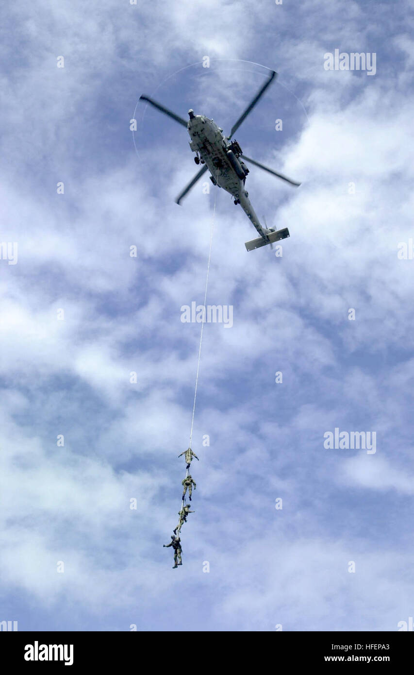 031005-N-2385R-004 Western Pacific Ocean (Oct. 5, 2003) -- Explosive Ordnance Disposal Mobile Unit Eleven Detachment One (EODMU-11, DET 1) suspend themselves from a repelling rope attached to a HH-60H Seahawk assigned to the 'Indians' of Helicopter Anti-Submarine Warfare Squadron Six (HS-6) during a practice air show aboard USS Nimitz (CVN 68).  The Nimitz Carrier Strike Group and her embarked Carrier Air Wing Eleven (CVW-11) are on deployment in the Western Pacific.  U.S. Navy photo by Photographer's Mate 3rd Class Yesenia Rosas.  (RELEASED) US Navy 031005-N-2385R-004 Explosive Ordnance Dispo Stock Photo