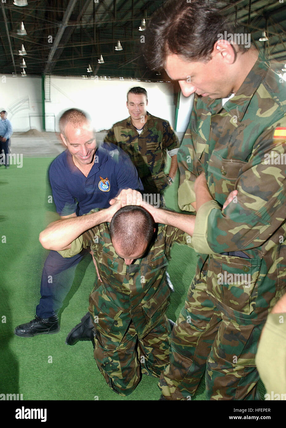 031014-N-2779T-004 Bahia Blanca, Argentina (Oct. 14, 2003) -- Sailors from South America and Spain get together to practice police apprehension techniques during a Maritime Interdiction Operations (MIO) training seminar conducted by members of the U.S. Coast Guard International Training Division.  Sailors from six nations participated in this training evolution scheduled as part of UNITAS, hosted by Argentina.  Sponsored by U.S. Naval Forces Southern Command, UNITAS is the largest multi-national maritime exercise in the western hemisphere.  During UNITAS Atlantic phase, naval forces from Argen Stock Photo