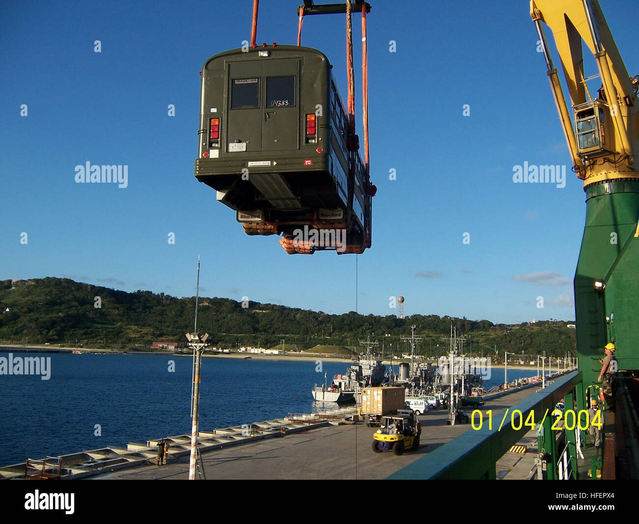 041210-N-3430B-005 Okinawa, Japan (Dec. 10, 2004) - Personnel assigned to Naval Expeditionary Logistics Support Force (NAVELSF), Forward Group Charlie, offload a bus during exercise Trident Arch XII, a cargo handling exercise in Okinawa, Japan from Dec. 9-12, 2004. NAVELSF Forward Group Charlie provided contributory support to the Fleet Hospital Support Office as part of the cargo handling exercise, safely offloading Fleet Hospital Two Zero (FH-20) equipment from the Dutch general cargo ship 'Marissa Green.' U.S. Navy photo by Chief Yeoman Jo-Ann Barnes (RELEASED) US Navy 041210-N-3430B-005 Pe Stock Photo