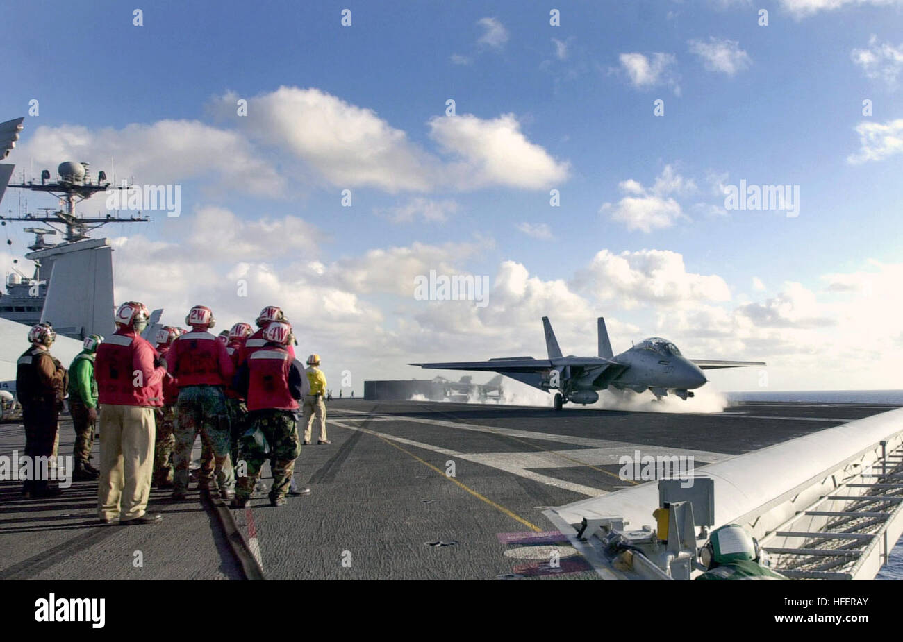 Flight deck personnel observe an F-14D Tomcat launch from USS John C ...