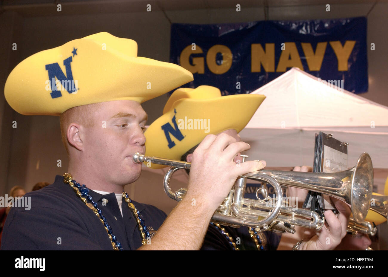 031229-N-9693M-002 Houston, Texas (Dec. 29, 2003) Ð U.S. Naval Academy (U.S.N.A.) Midshipmen 4th Class Jason Pallota, from Daytona, Fla., plays the trumpet during the EV1.Net Rodeo Pep Rally in Reliant Arena.  Navy, 8-4, will play Texas Tech, 7-5, on Dec. 30.  This marks the 10th bowl appearance for Navy with their last bowl match-up in 1996. U.S. Navy photo by Damon J. Moritz.  (RELEASED) US Navy 031229-N-9693M-002 U.S. Naval Academy (U.S.N.A.) Midshipmen 4th Class Jason Pallota, from Daytona, Fla., plays the trumpet during the EV1.Net Rodeo Pep Rally in Reliant Arena Stock Photo
