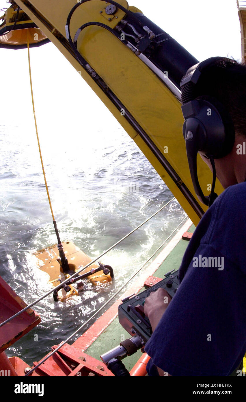 040426-N-7949W-011 Pacific Ocean (Apr. 26, 2004) - Machinist's Mate 3rd Class Derrick Lines guides 'Super Scorpio', a remote operated vehicle (ROV) into position for safe recovery aboard the special mission charter ship M/V Kellie Chouest. Petty Officer Lines is assigned to Deep Submergence Unit (DSU) Unmanned Vehicle Detachment (UMV Det), tasked with surveying the wreckage of an F-14D Tomcat that crashed off the coast of Point Loma, Calif. Kellie Chouest is one of four Submarine Support Vessels belonging to the Military Sealift Command (MSC) Special Mission Ships Program. U.S. Navy photo by P Stock Photo