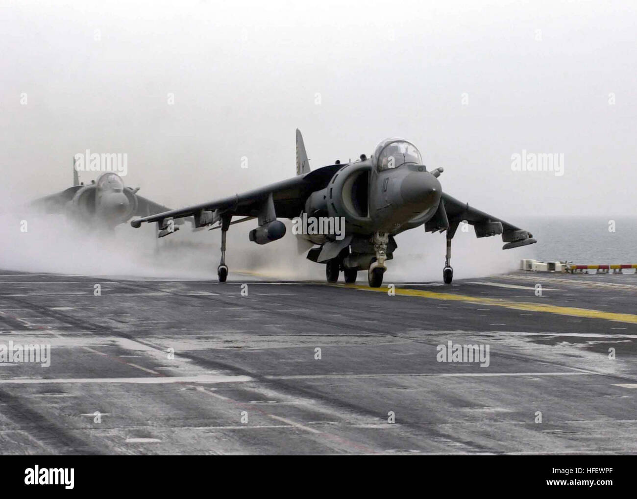 030224-N-6610T-519 Aboard USS Bataan (LHD 5) Feb. 24, 2003 - An AV-8B Harrier jump jet assigned to the ÒTigersÓ of Marine Attack Squadron Five Four Two (VMA-542) prepares to takes off from the flight deck of the amphibious assault ship USS Bataan (LHD 5). The Harrier is carrying the newer AN/AAQ-28 Litening targeting pod on its starboard wing pylon. The pod is an advanced airborne targeting and navigation pod that is designed to improve both day and night attack capabilities and improve low level night flights. U.S. Navy photo by PhotographerÕs Mate 3rd Class John Taucher. (RELEASED) US Navy 0 Stock Photo