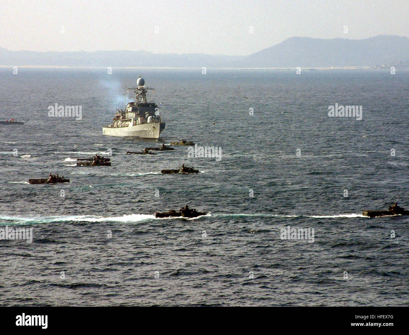 040326-N-6482H-003 At sea aboard USS Fort McHenry (LSD 43) Mar. 26, 2004 - Amphibious Assault Vehicles (AAV) assigned to Battalion Landing Team (BLT) 2/3 and the Republic of Korea group together in front of Republic of Korea Tank Landing Ship Seongin Bong (LST 685) in preparation of a beach landing during Exercise Reception, Staging, Onward movement and Integration (RSOI) and Foal Eagle. RSOI and Foal Eagle are a combined exercise involving forces from the United States and the Republic of Korea to enhance training opportunities and teach, coach and mentor service members, while exercising sen Stock Photo