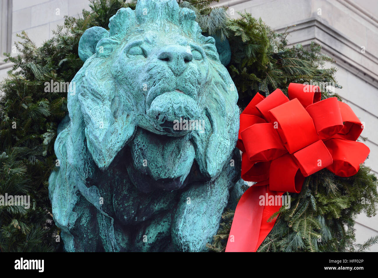 The bronze lions greeting visitors outside of the Art Institute of Chicago are decorated for the Holiday Season. Stock Photo