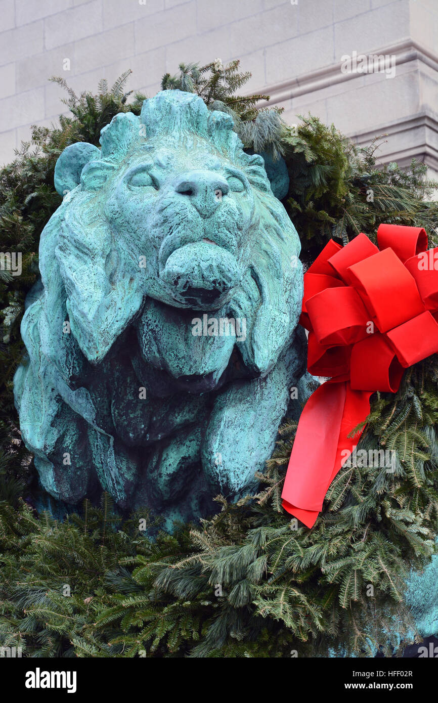 The bronze lions greeting visitors outside of the Art Institute of Chicago are decorated for the Holiday Season. Stock Photo