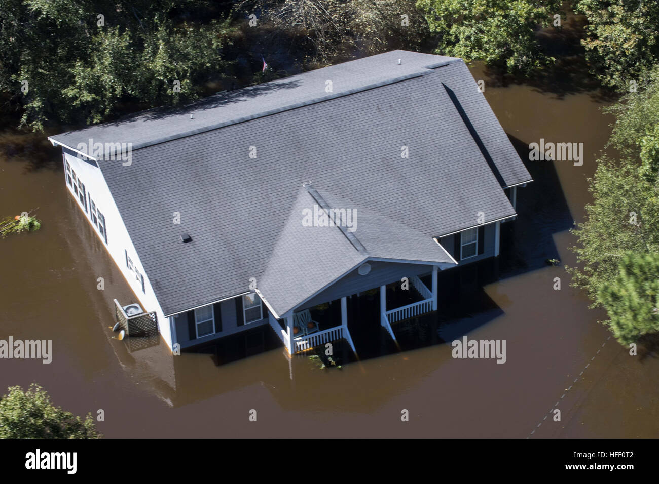 Aerial view of a house submerged in flood water after a hurricane hit