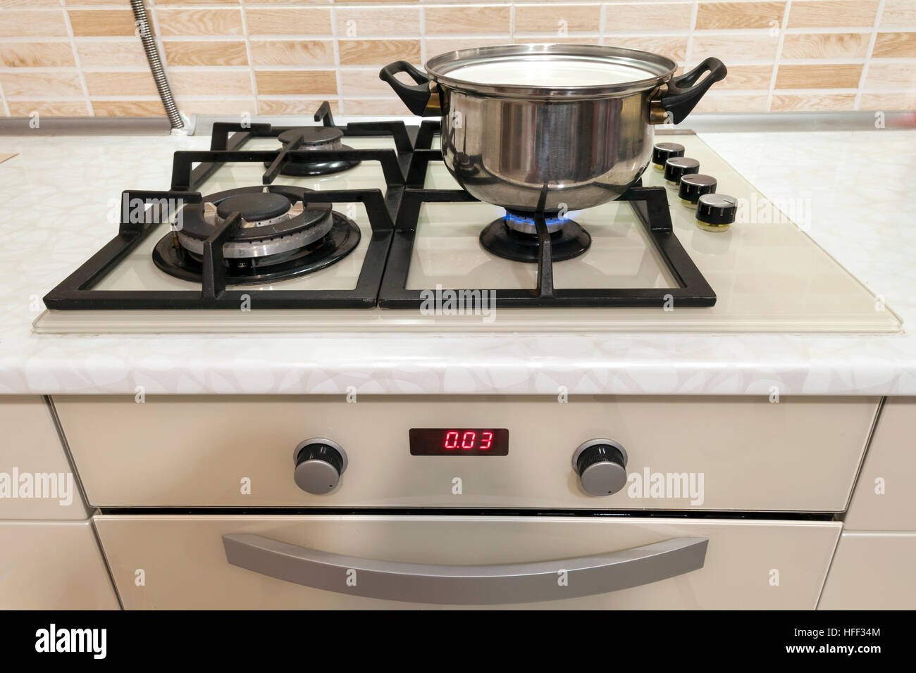 Closeup of stainless steel cooking pot on gas stove in contemporary