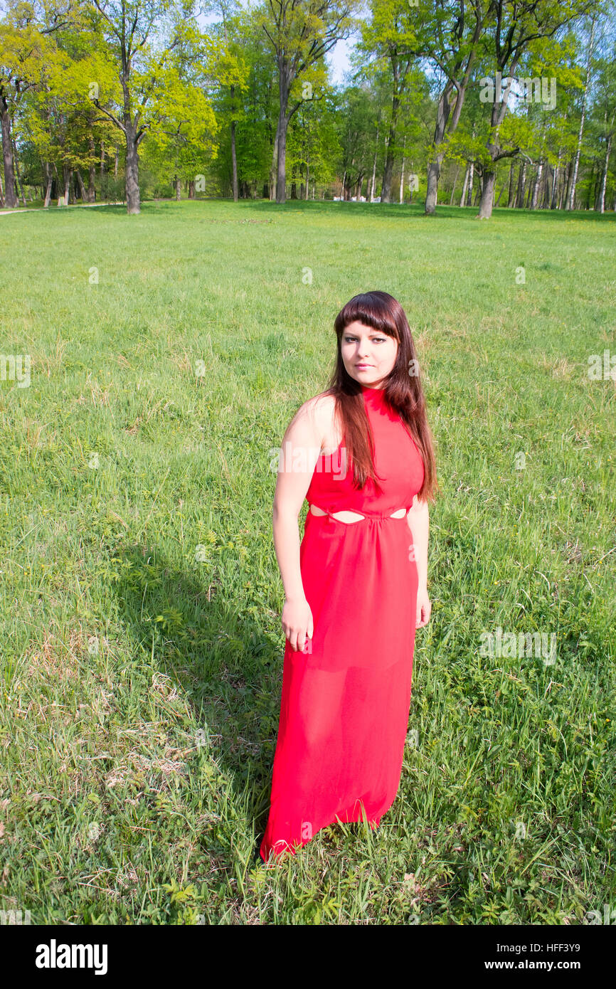 girl in the red and the green green grass. Park and beauty Stock Photo ...