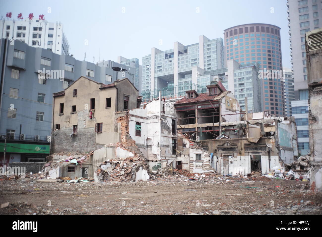 Destruction of Shanghai Longtangs. -  13/04/2016  -  China / Shanghai  -  Awaiting the demolition. Destruction of Shanghai Longtangs. At the beginning of the '80s, the majority of the population was living in Longtangs, that it to say small villages into cities. Ther destruction follows the growth curve, thus hectares of land await the promoter who will decide to build a Mall or a bar of buildings. Some owners are resisting and keep living in their home. Water and electricity are then cut off. The othr receive a compensation and are sent to the suburbs. Everything is recycled and used in order Stock Photo