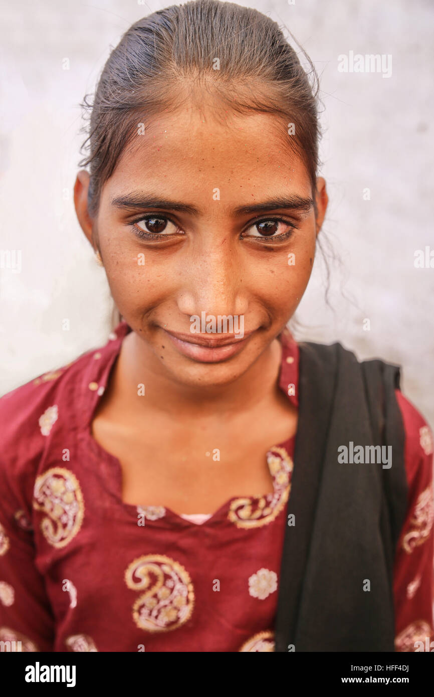 Portraits of women and children of Rajasthan. In the countryside, the women of Rajasthan wear long skirts, a small bolero and veil with bright colors. They adorn themselves with silver jewels ( earrings, nose rings, necklaces, arm and ankle bracelets). They raise the children and participate in the rural works ( cattle, farming, wood and water tasks). Most of the marriages are settled and the place of women is by and at the service of their in-laws.  -  23/04/2016  -  India / Rajasthan  -  Pictures of Rajasthan, portraits and lifestyles   -  Sandrine Huet / Le Pictorium Stock Photo