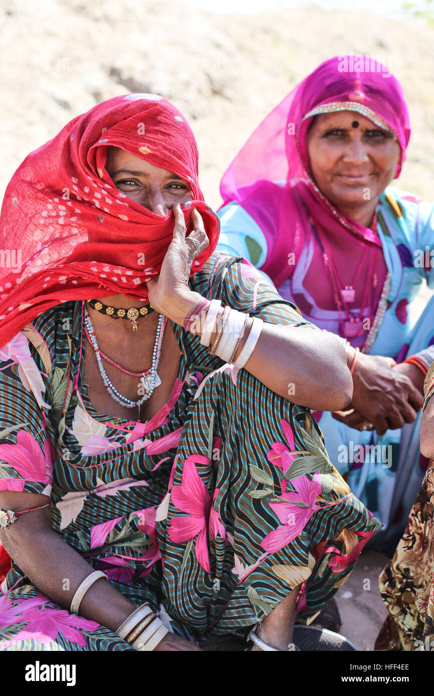 Portraits of women and children of Rajasthan. In the countryside, the women of Rajasthan wear long skirts, a small bolero and veil with bright colors. They adorn themselves with silver jewels ( earrings, nose rings, necklaces, arm and ankle bracelets). They raise the children and participate in the rural works ( cattle, farming, wood and water tasks). Most of the marriages are settled and the place of women is by and at the service of their in-laws.  -  22/04/2016  -  India / Rajasthan  -  Pictures of Rajasthan, portraits and lifestyles   -  Sandrine Huet / Le Pictorium Stock Photo